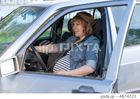 Pregnant woman in driving seat of the car Pregnant woman in driving seat of the car 4874225