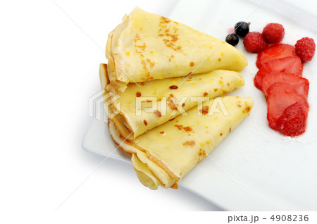 Crepe on a plate with a strawberry, a raspberry and a bilberry Crepe on a plate with a strawberry, a raspberry and a bilberry 4908236