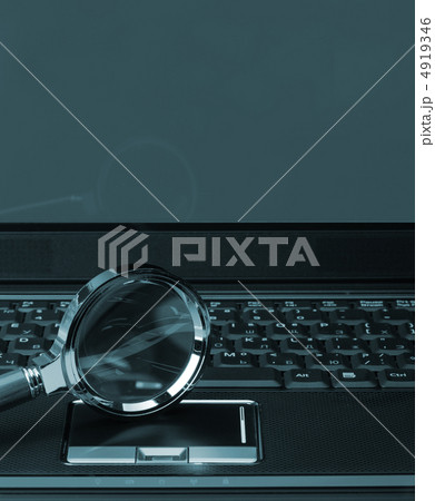 Magnifying glass and a laptop 4919346