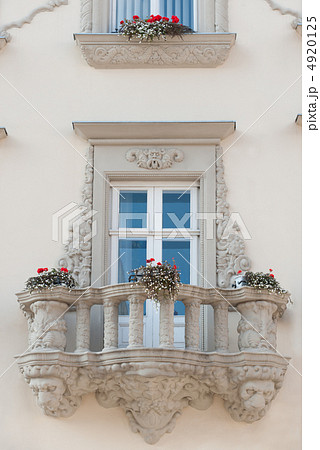 Facade of a building with a balcony and flowers 4920125