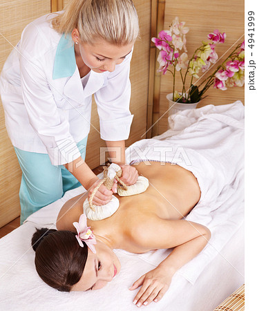 Young woman on massage table in beauty spa. 4941999
