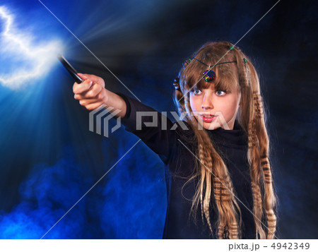 Girl in witch's hat with magic wand. Girl in witch's hat with magic wand. 4942349