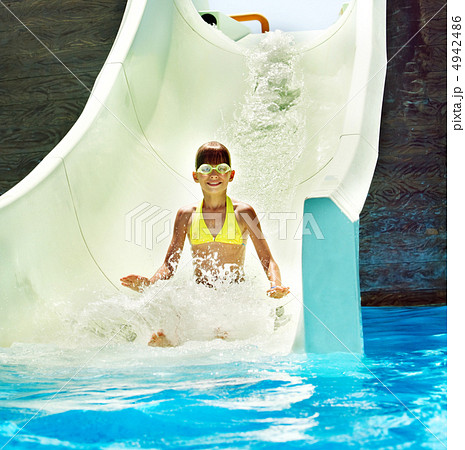 Child on water slide at aquapark. Child on water slide at aquapark. 4942486