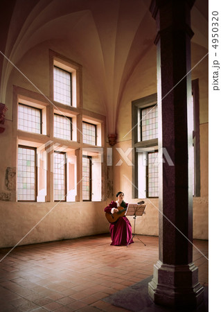 Woman playing guitar in Malbork Castle. 4950320