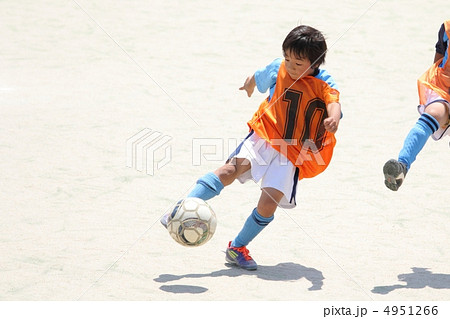 サッカー少年の華麗なボレーシュートの写真素材