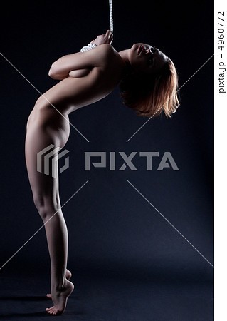 nude woman bind with rope stand in dark 4960772