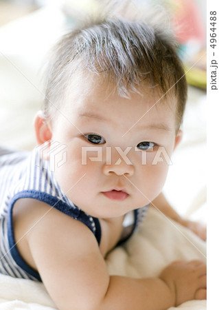 澄んだ瞳で見つめる赤ちゃんの写真素材
