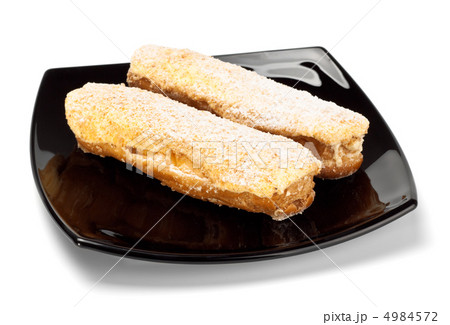 two eclairs on black dish two eclairs on black dish 4984572
