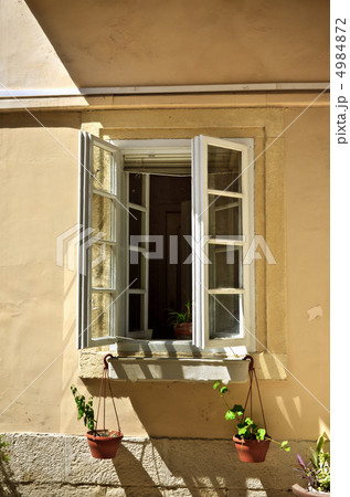 opened window with flowerpots opened window with flowerpots 4984872