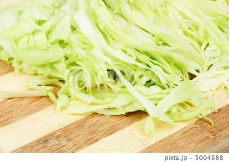 Green cabbage sliced on cutting board Green cabbage sliced on cutting board 5004688