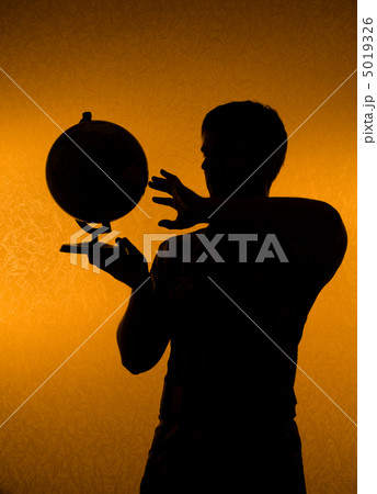 Discover the world - silhouette of man holding globe Discover the world - silhouette of man holding globe 5019326