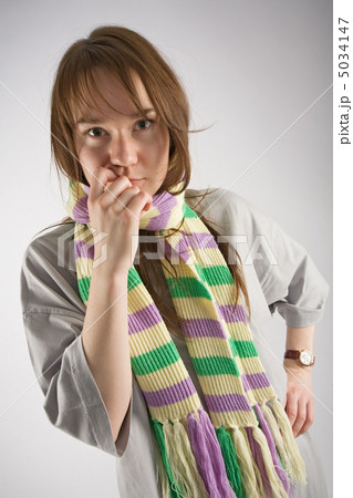 thoughtful young woman in striped muffler thoughtful young woman in striped muffler 5034147