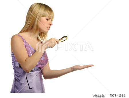 The girl looking at a hand through a magnifier 5034811