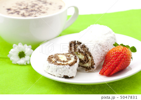 Cappuccino with a sweet roll isolated on white Cappuccino with a sweet roll isolated on white 5047831
