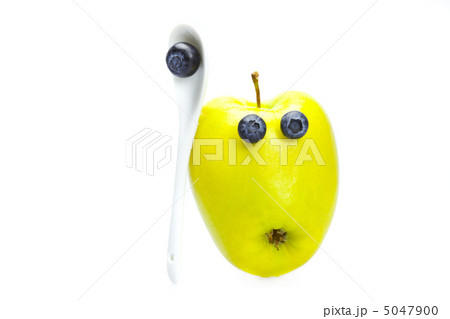 apple with eyes of blueberries isolated on white apple with eyes of blueberries isolated on white 5047900