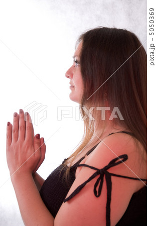 young woman praying 5050369