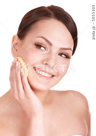 Young woman washing her face by sponge. 5055305
