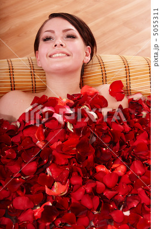 Young woman in rose petal swim water. Young woman in rose petal swim water. 5055311