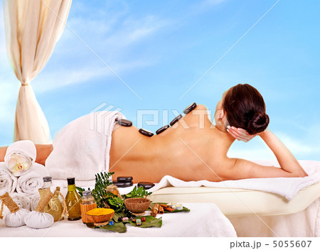 Woman getting spa lastone therapy outdoor. 5055607