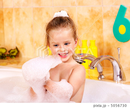 Child washing in bubble bath . 5056730