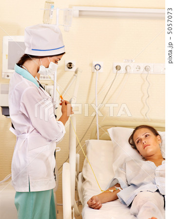 Doctor treats patient with stethoscope. 5057073