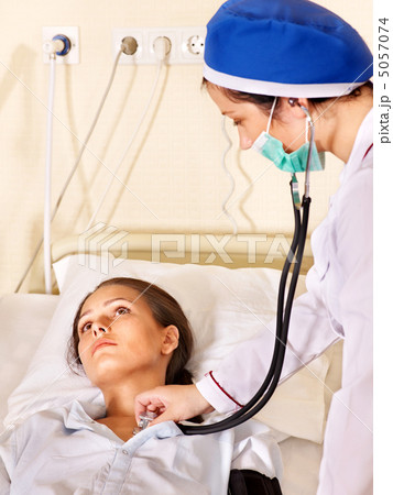Doctor treats patient with stethoscope. Doctor treats patient with stethoscope. 5057074