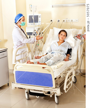 Doctor treats patient with defibrillator. 5057075