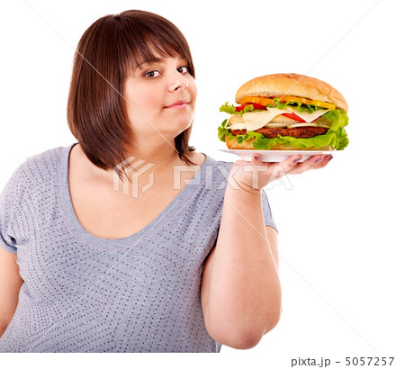 Woman eating hamburger. 5057257