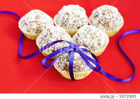 cake topped with coconut bandaged tape on a red background 5072995