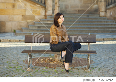 beautiful young woman sitting on a bench beautiful young woman sitting on a bench 5073292