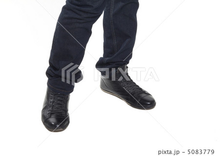 Man's feet in blue trousers and black shoes 5083779