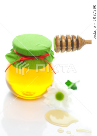 stick to hohey ,flower and jar of honey isolated on white stick to hohey ,flower and jar of honey isolated on white 5087590