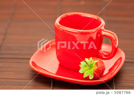 Cup and saucer and strawberries on a bamboo mat 5087766