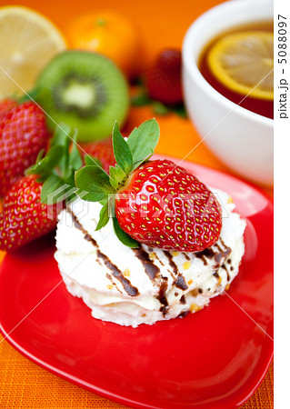 lemon tea,lemon, mandarin, kiwi,cake and strawberries lying on t 5088097