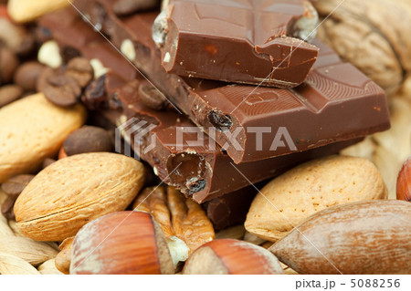 bar of chocolate and nuts on a wicker mat 5088256