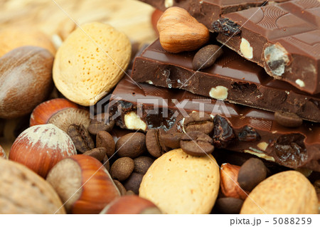 bar of chocolate and nuts on a wicker mat bar of chocolate and nuts on a wicker mat 5088259