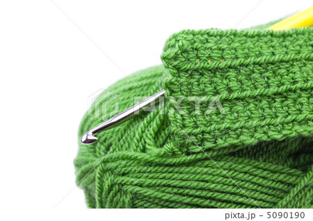 Skein of wool, crochet hook  and knitted piece isolated on white 5090190