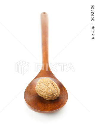walnut in a wooden spoon isolated on white 5092406