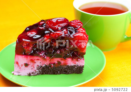 beautiful cake with berries on a plate and a cup of tea on the o beautiful cake with berries on a plate and a cup of tea on the o 5092722