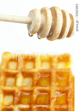 delicious Belgian waffles and stick to honey isolated on white 5092965
