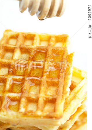 delicious Belgian waffles and stick to honey isolated on white 5092974