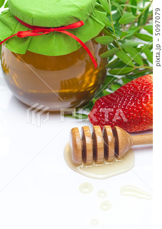 stick to hohey and  jar of honey  isolated on white 5097079