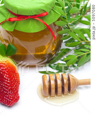 stick to hohey,strawberries and jar of honey isolated on whit stick to hohey,strawberries and jar of honey isolated on whit 5097080