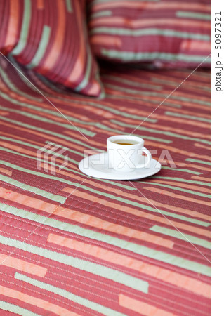 bed with two pillows, a cup of tea on the blanket bed with two pillows, a cup of tea on the blanket 5097321