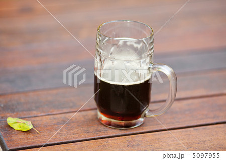 mug with dark beer standing on the table 5097955