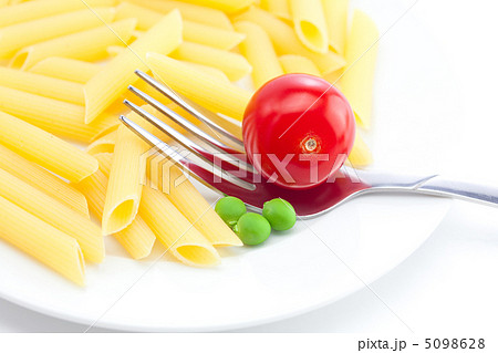 tomatoes, peas, pasta and fork on a plate isolated on white tomatoes, peas, pasta and fork on a plate isolated on white 5098628
