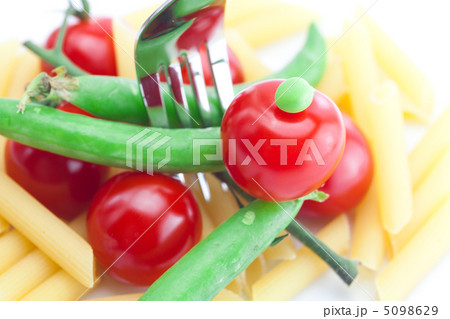 tomatoes, peas, pasta and fork on a plate isolated on white tomatoes, peas, pasta and fork on a plate isolated on white 5098629
