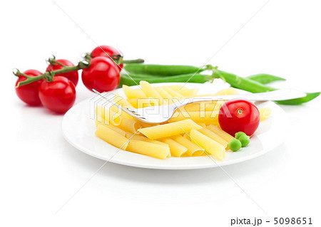tomatoes, peas, pasta and fork on a plate isolated on white 5098651