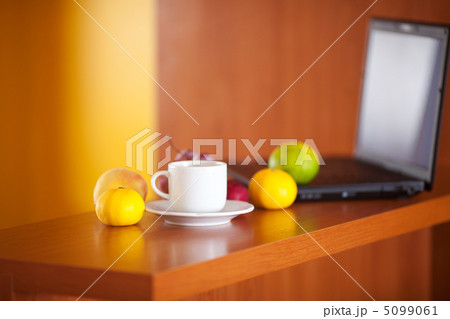 laptop,cup and fruits on the desk 5099061