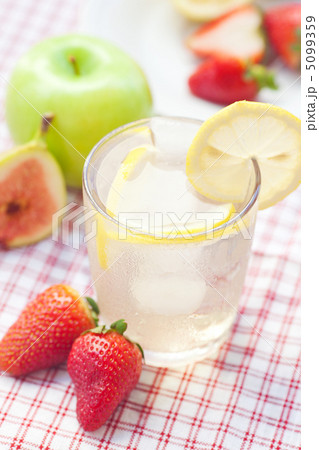 cocktail with ice,lemon, fig and strawberries on a plate cocktail with ice,lemon, fig and strawberries on a plate 5099359
